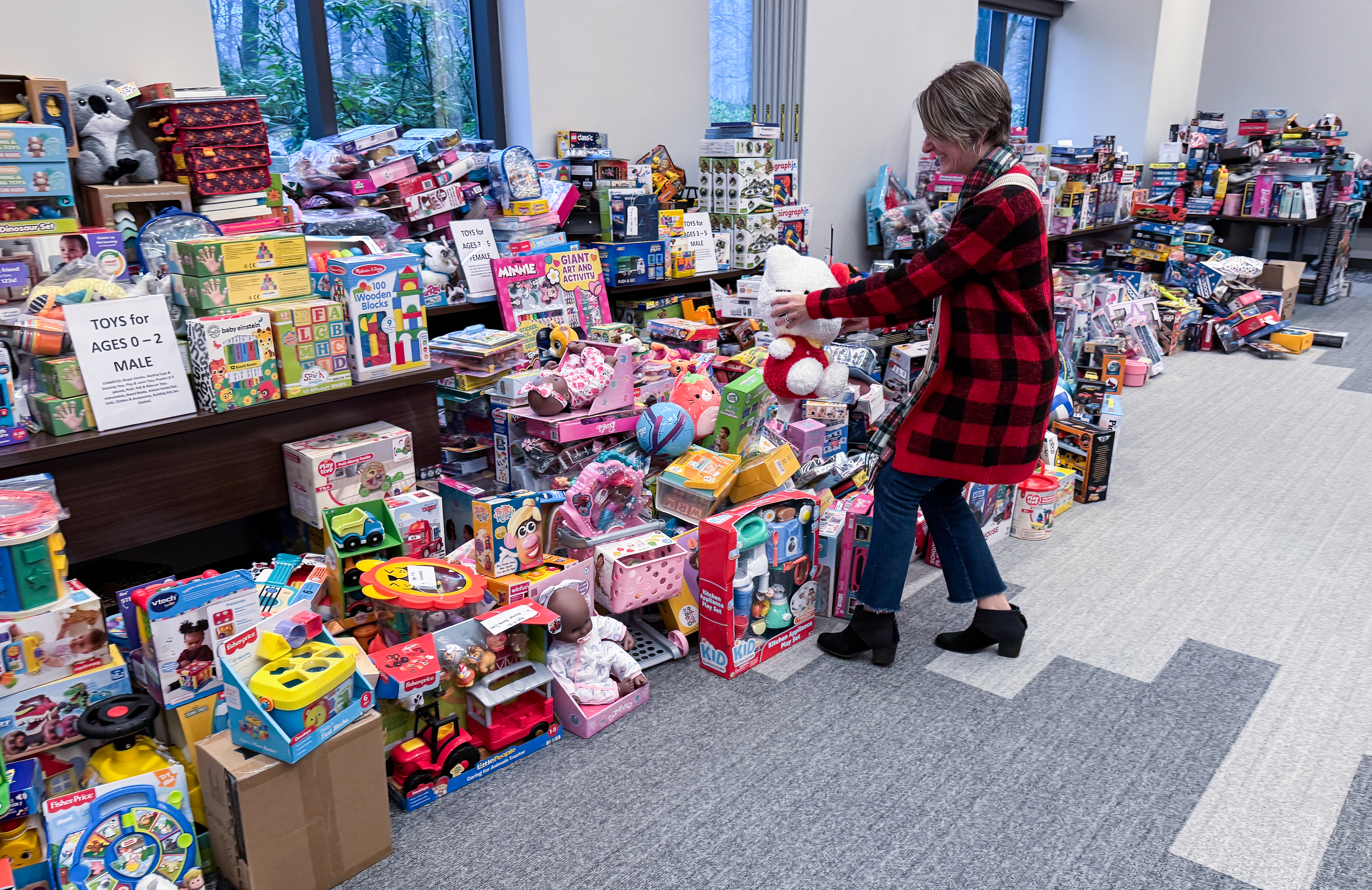 Erin Alligood, Chief Human Resources Officer, places a donation from ARIN’s Toy Drive amongst the gifts collected by NVFS.
